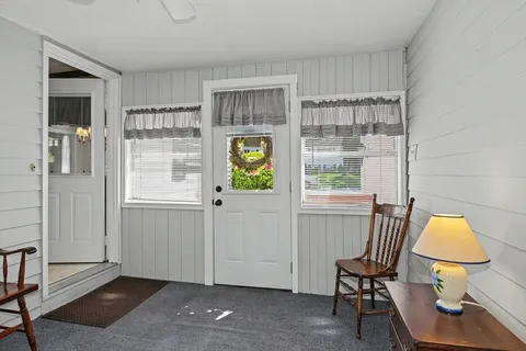 a view of workspace with wooden floor windows and chair
