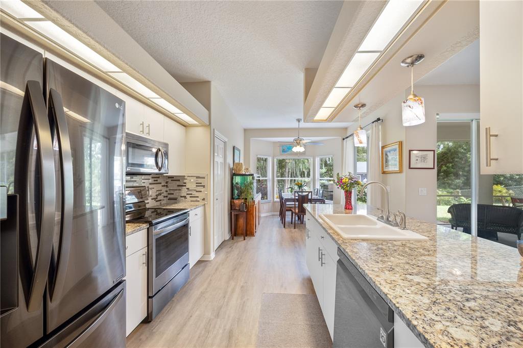 8131 Baytree Drive New Port Richey, FL 34653 - Photo 16 of 35 Beautiful kitchen with stainless steel appliances, granite counter and ceramic sink