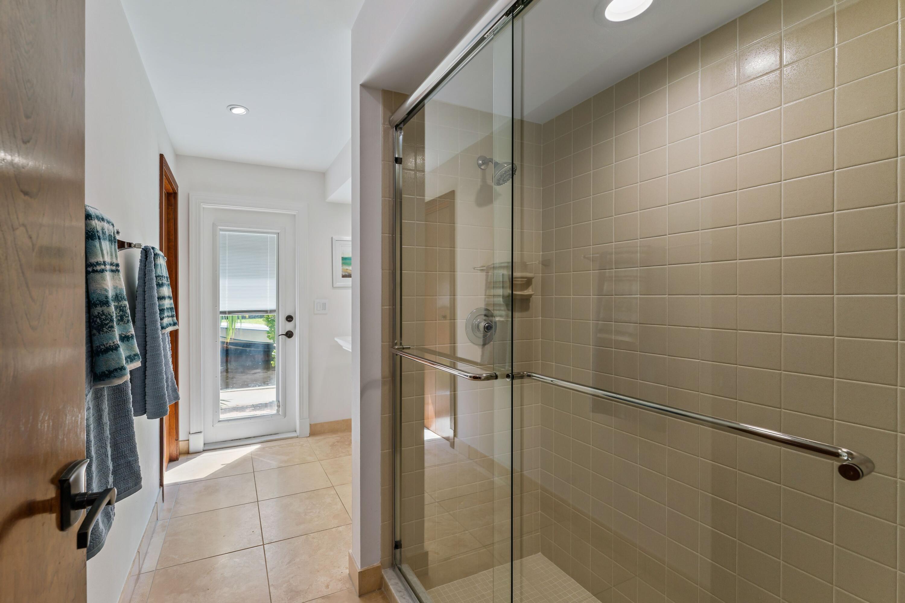 18150 Perigon Way Jupiter, FL 33458 - Photo 24 of 57 a bathroom with a glass shower door