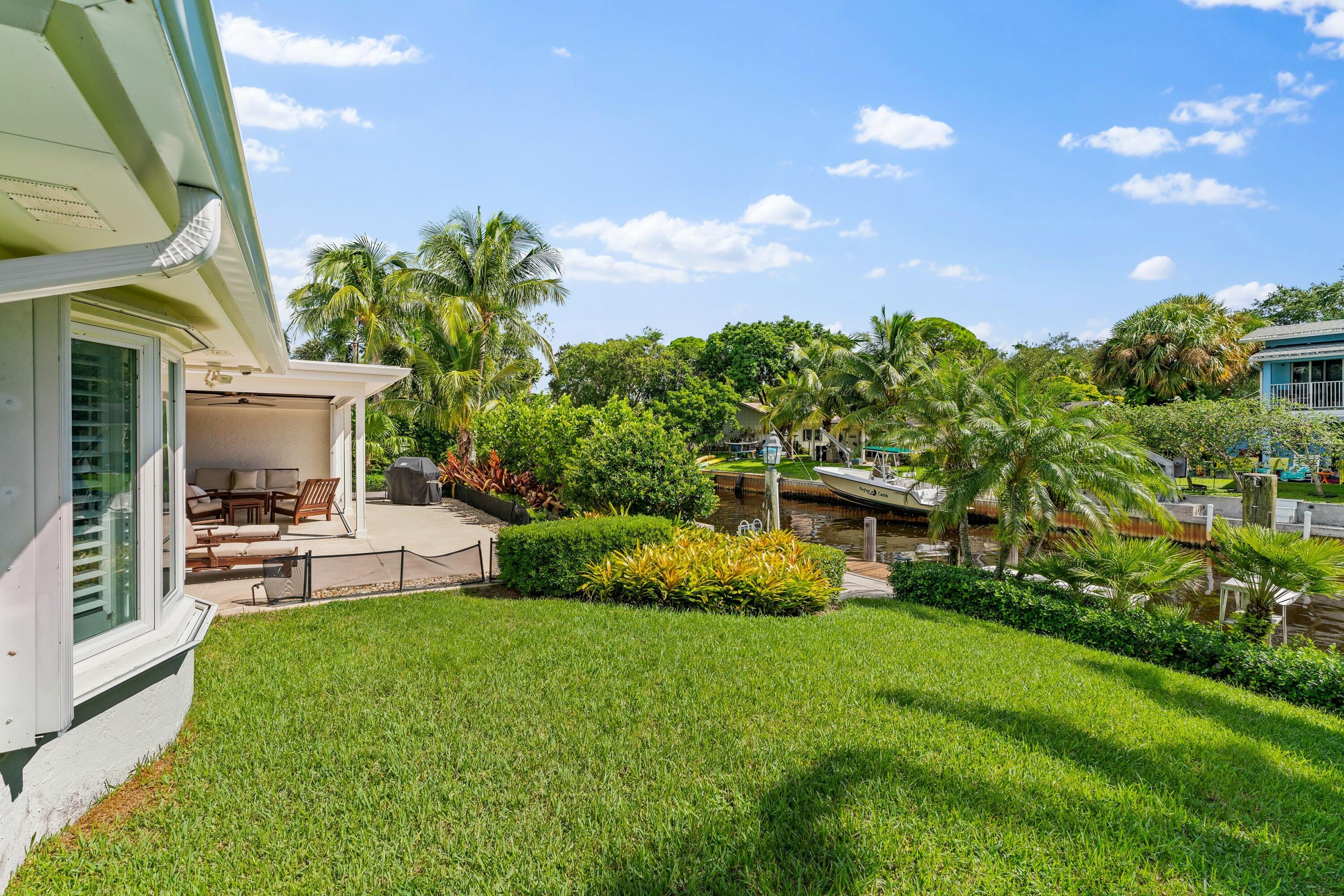 18150 Perigon Way Jupiter, FL 33458 - Photo 35 of 57 a view of house with backyard porch and garden