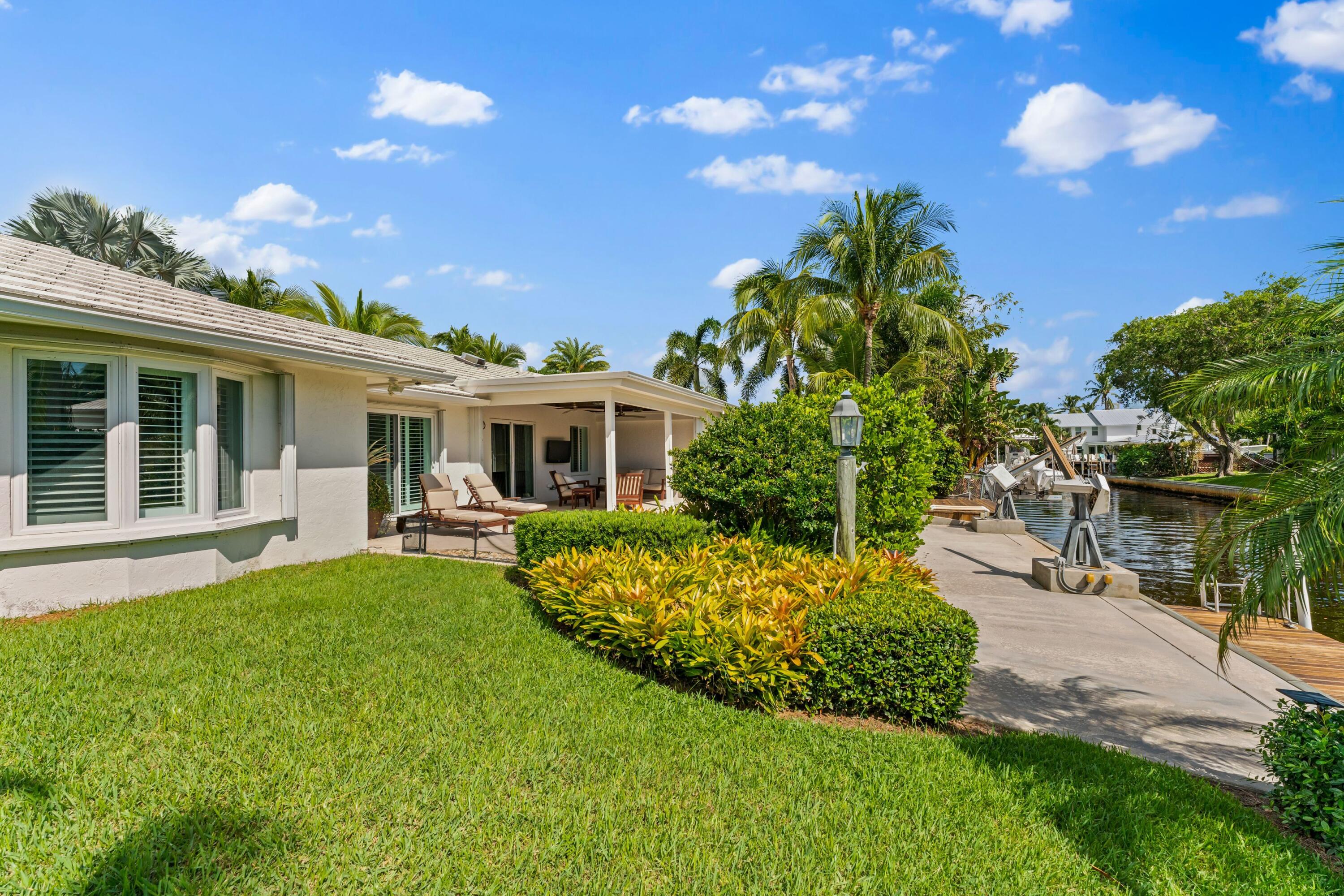 18150 Perigon Way Jupiter, FL 33458 - Photo 36 of 57 a front view of house with yard and outdoor seating