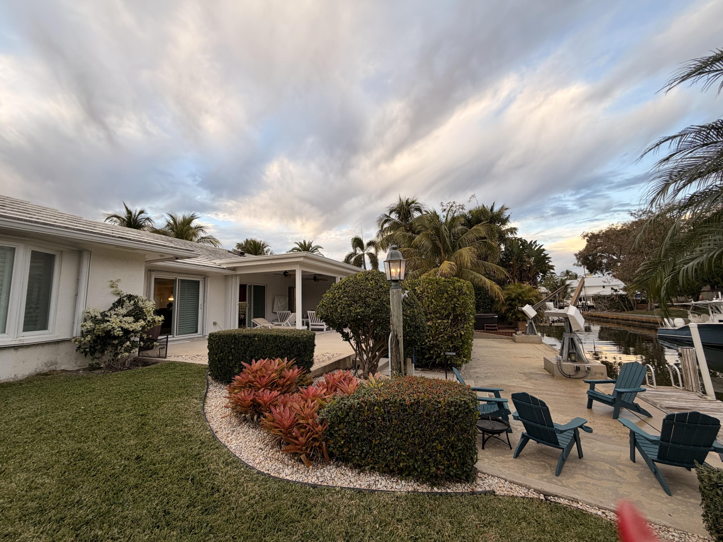 18150 Perigon Way Jupiter, FL 33458 - Photo 37 of 57 a view of a house with backyard sitting area and garden