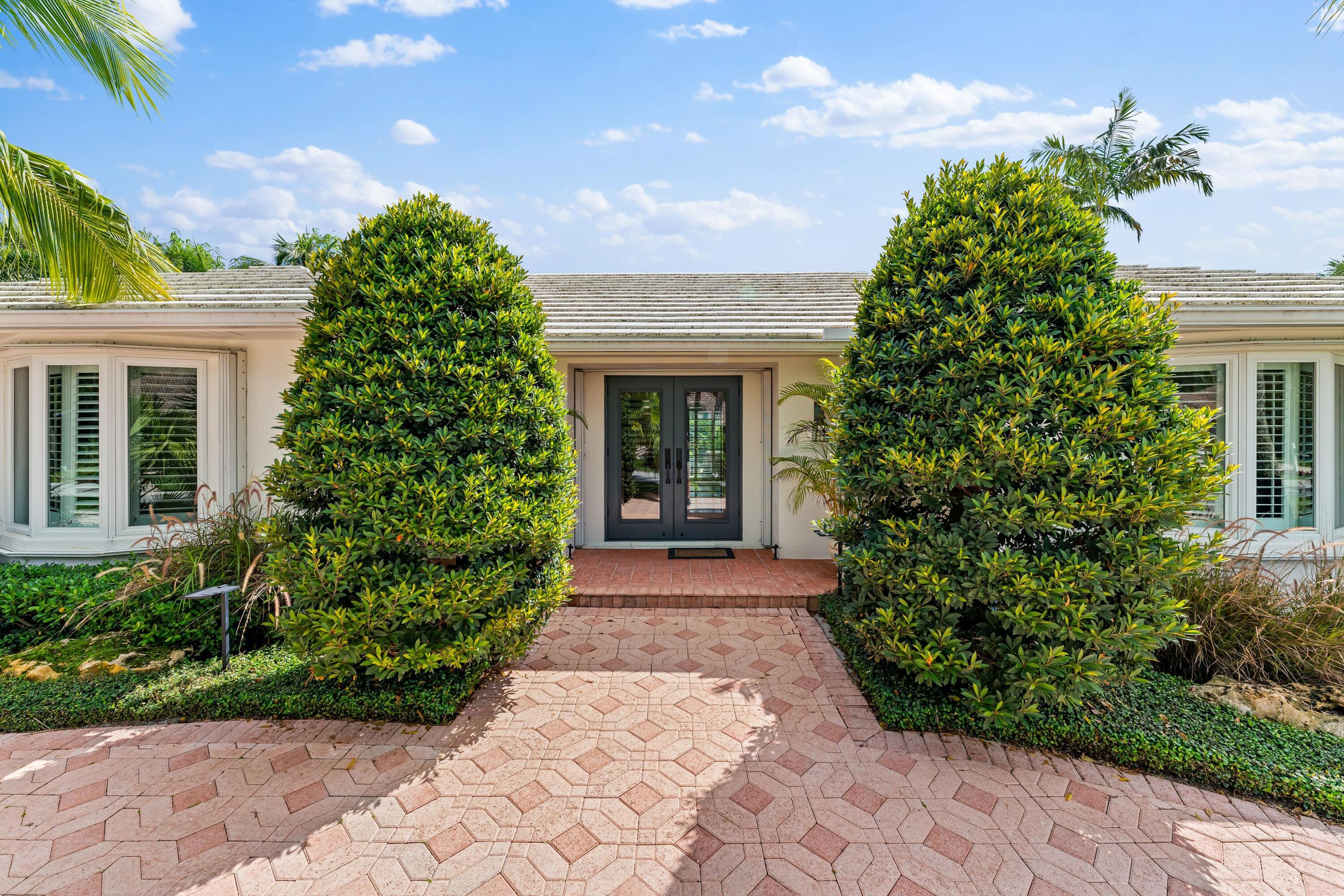 18150 Perigon Way Jupiter, FL 33458 - Photo 4 of 57 a front view of a house with garden