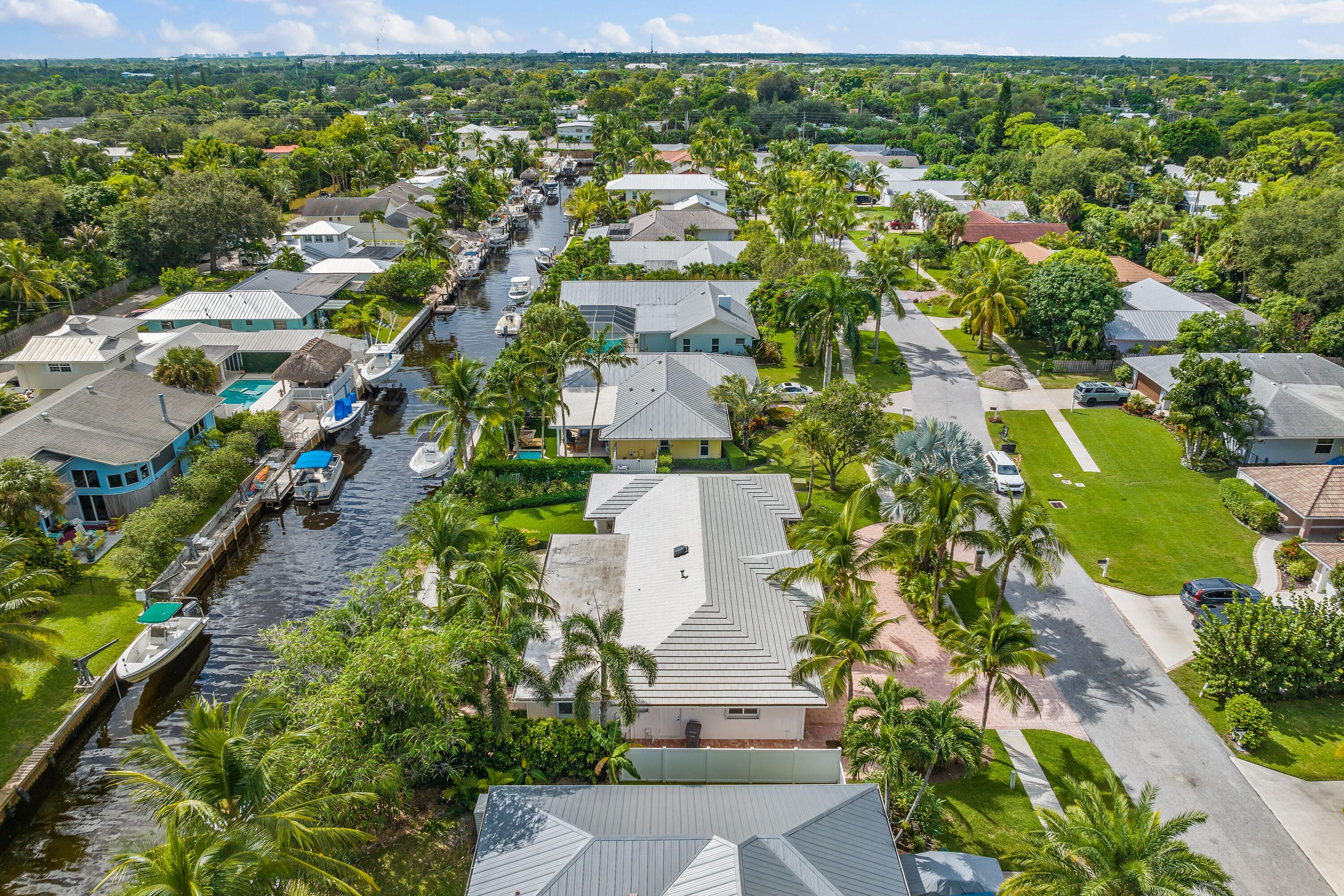 18150 Perigon Way Jupiter, FL 33458 - Photo 50 of 57 an aerial view of residential houses with outdoor space and trees