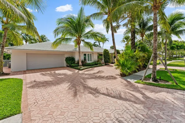 a front view of a house with a yard and a garage
