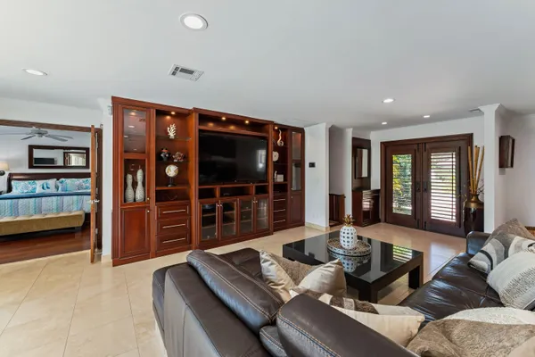 a living room with furniture a window and bookshelf
