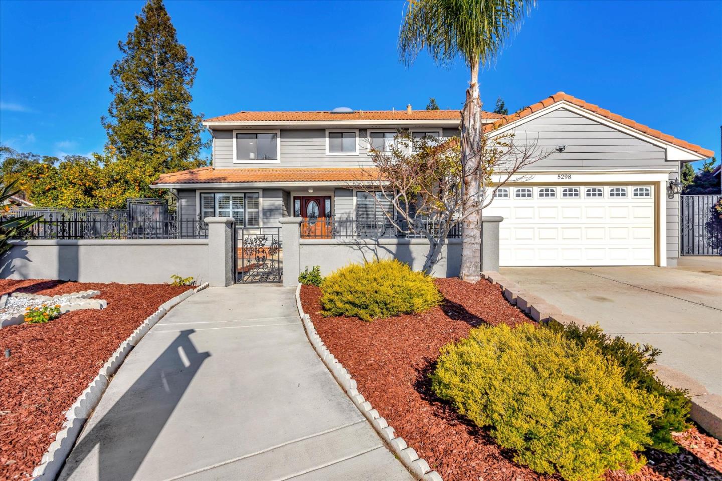 5298 Sunny Orchard Lane San Jose, CA 95135 - Photo 1 of 45 a front view of a house with a garden