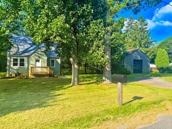 a house with swimming pool in front of it