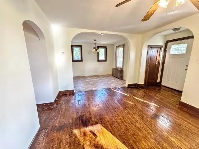 a view of empty room with wooden floor