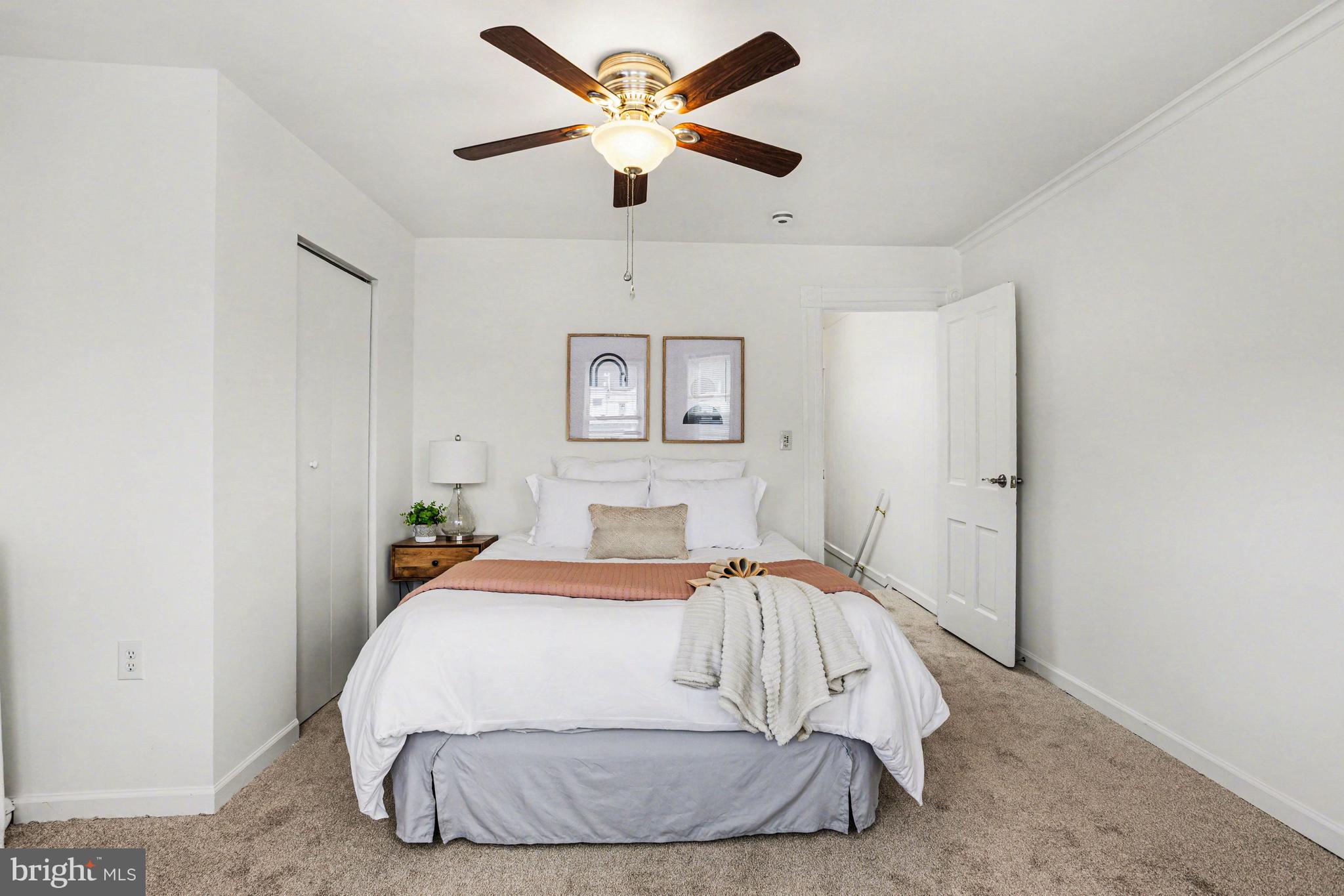 3616 Keystone Avenue Baltimore, MD 21211 - Photo 17 of 26 a bed room with a bed and a ceiling fan