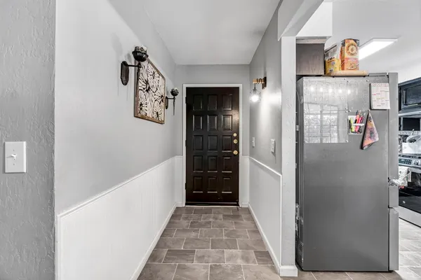 a view of a hallway with wooden shelves