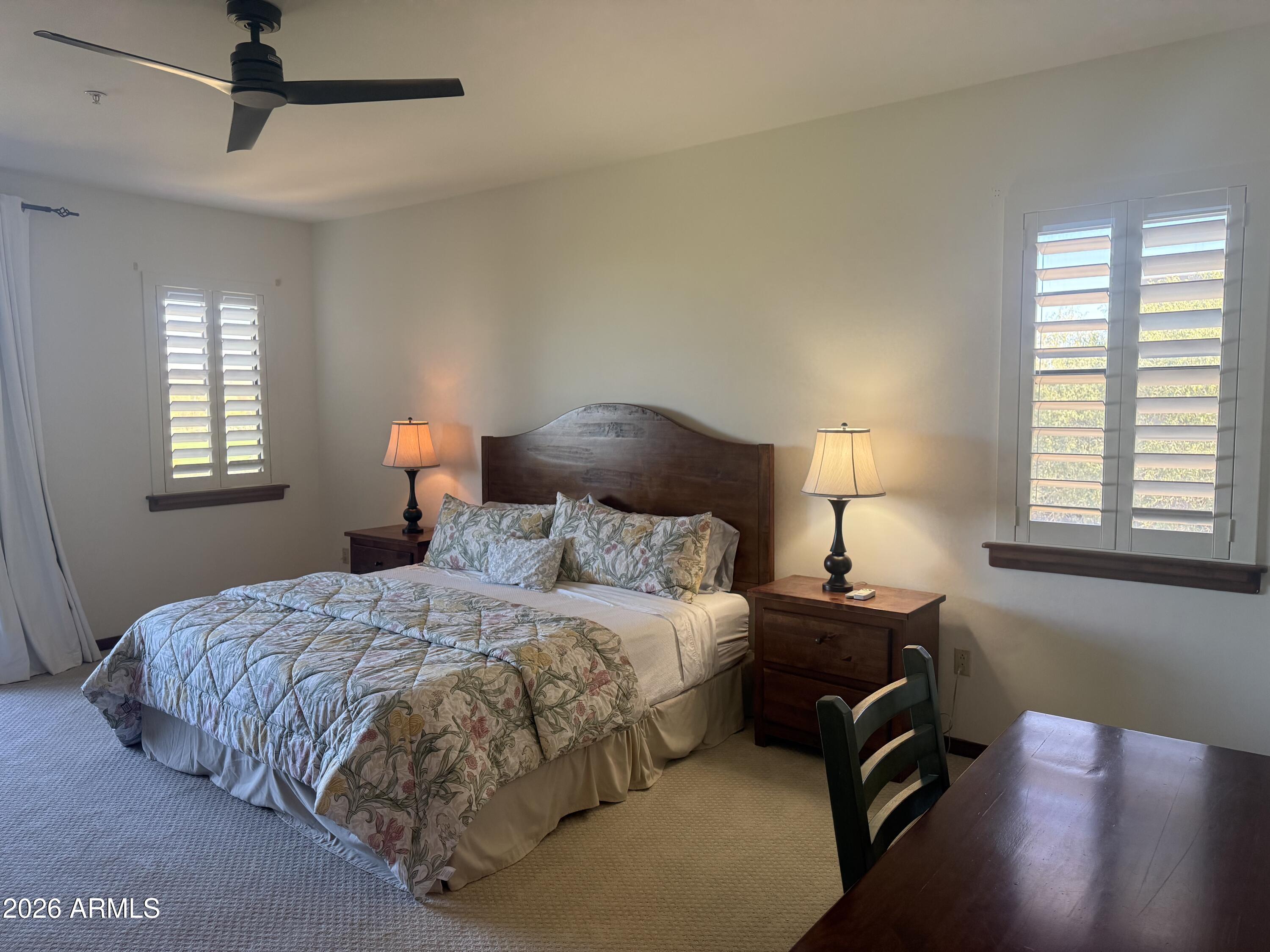 36601 North Mule Train Road, Unit D18 Carefree, AZ 85377 - Photo 22 of 57 a bedroom with a bed lamps and window