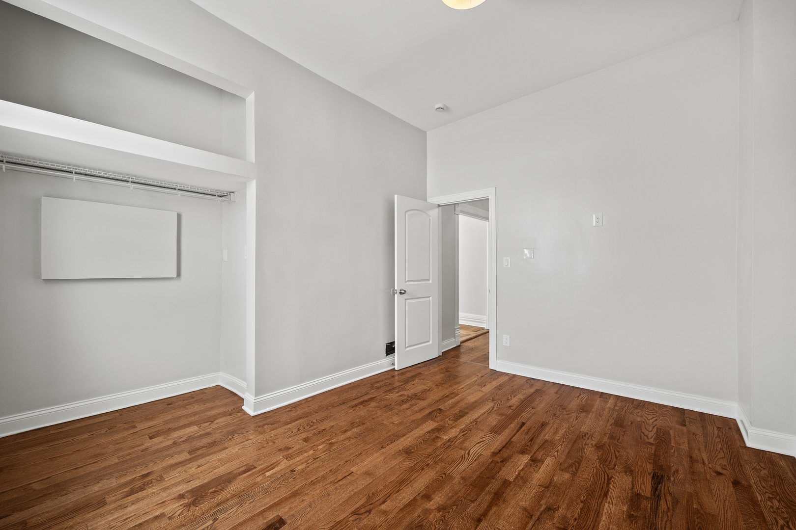3214 West Division Street, Unit 2 Chicago, IL 60651 - Photo 11 of 14 a view of an empty room with wooden floor and a window