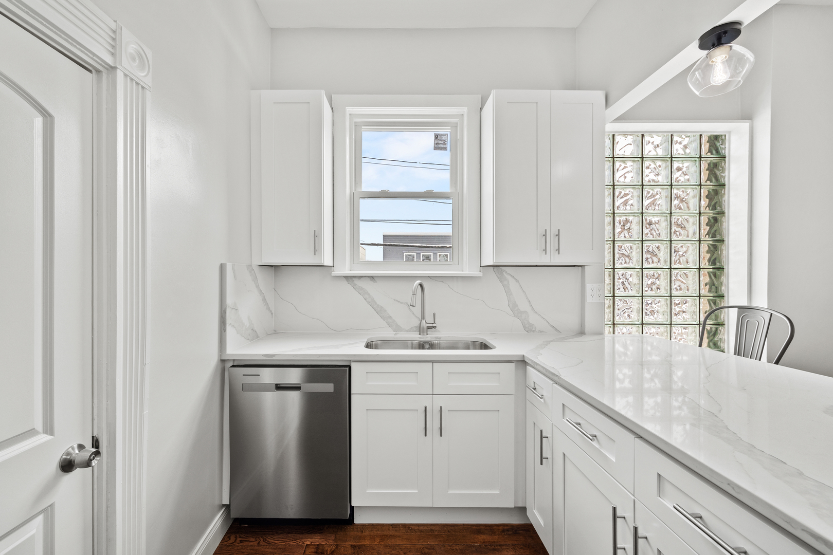 3214 West Division Street, Unit 2 Chicago, IL 60651 - Photo 3 of 14 a kitchen with a sink cabinets appliances and a window