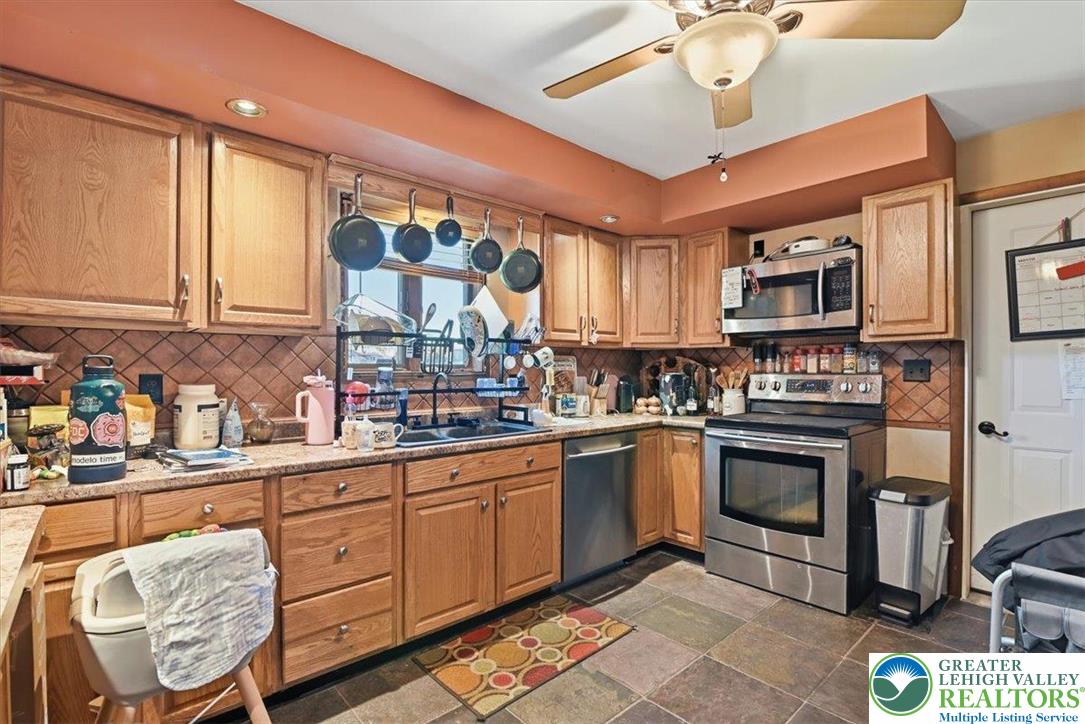 7567 Airport Road Bath, PA 18014 - Photo 20 of 67 a kitchen with stainless steel appliances granite countertop a stove sink and cabinets
