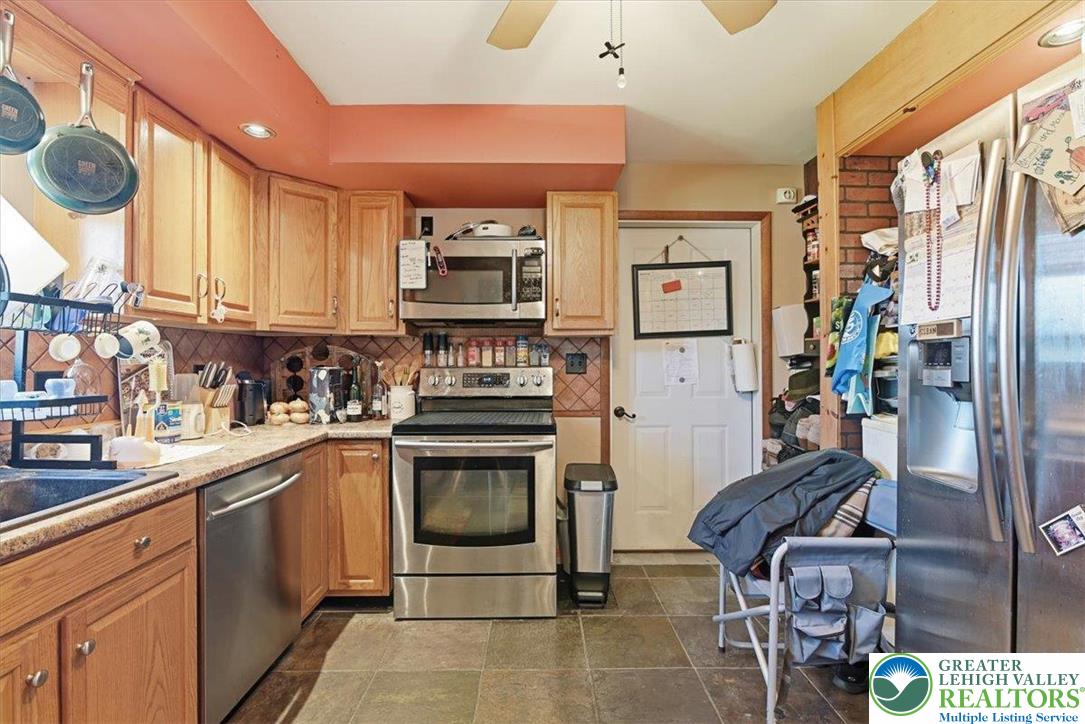 7567 Airport Road Bath, PA 18014 - Photo 21 of 67 a kitchen with stainless steel appliances a stove a sink and a refrigerator