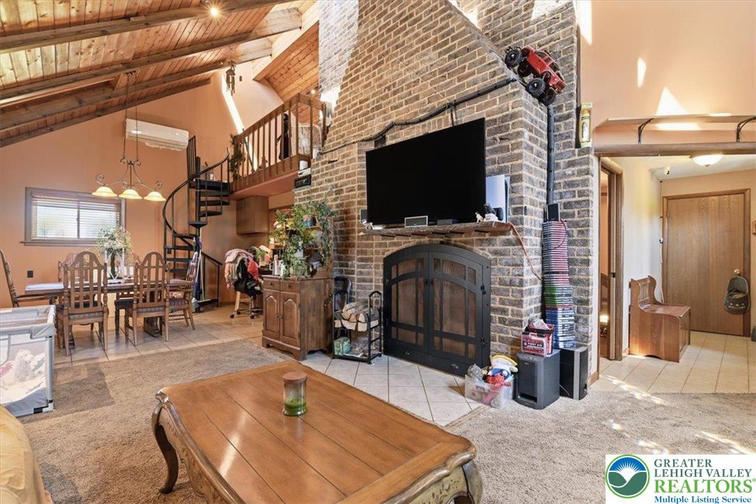 7567 Airport Road Bath, PA 18014 - Photo 27 of 67 a living room with furniture a flat screen tv and a fireplace