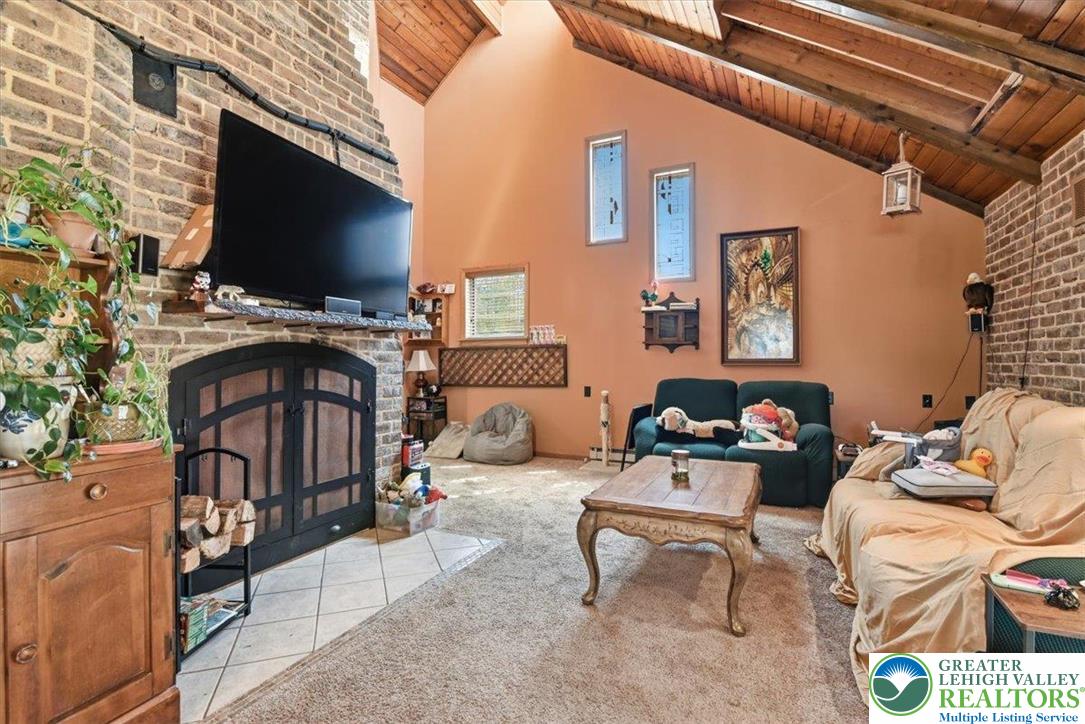 7567 Airport Road Bath, PA 18014 - Photo 28 of 67 a living room with furniture and a flat screen tv