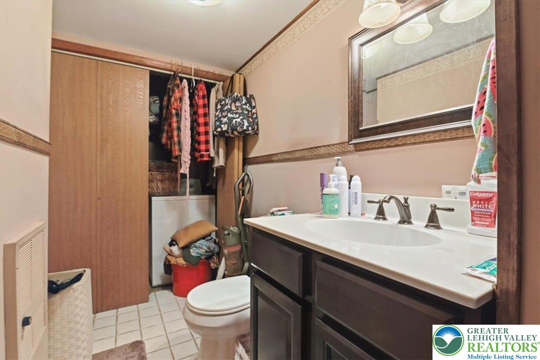 7567 Airport Road Bath, PA 18014 - Photo 36 of 67 a bathroom with a sink toilet vanity and window