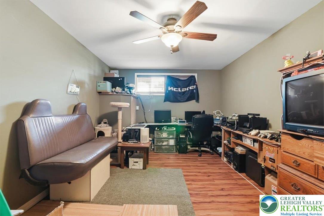 7567 Airport Road Bath, PA 18014 - Photo 45 of 67 a living room with furniture and a flat screen tv