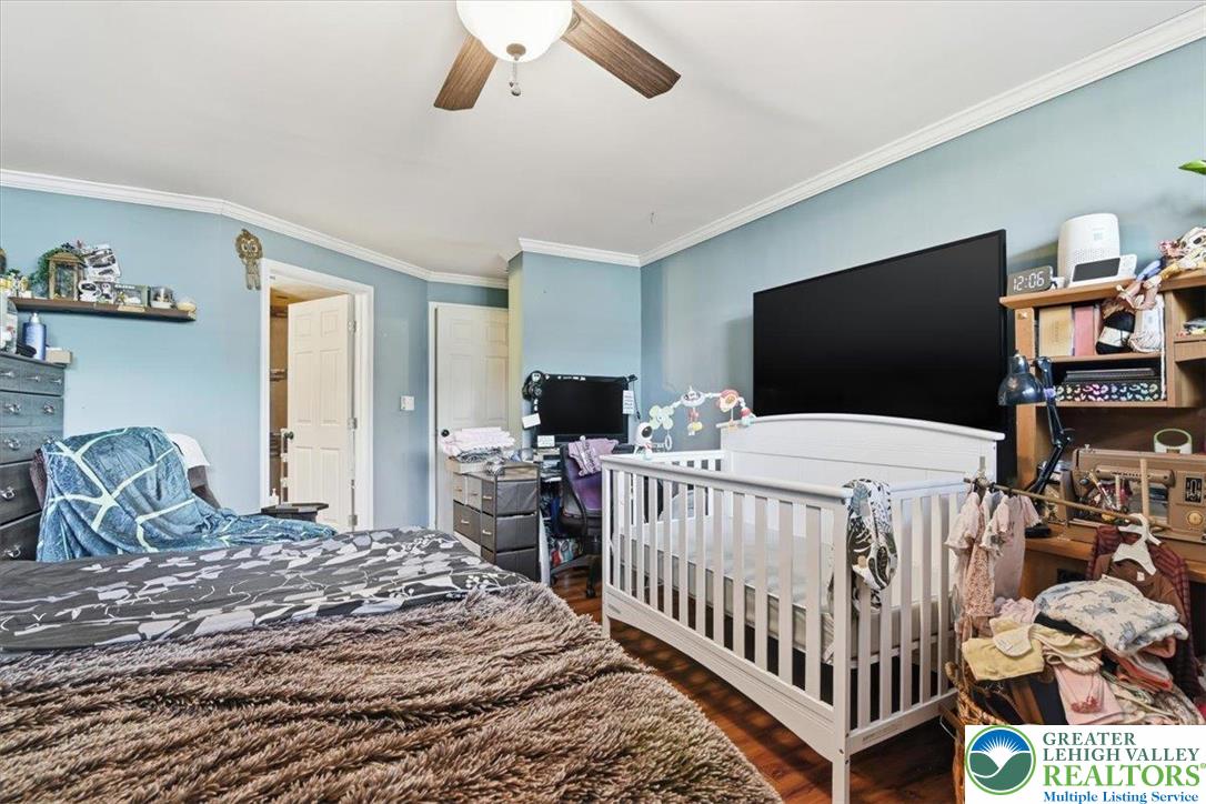 7567 Airport Road Bath, PA 18014 - Photo 54 of 67 a bedroom with a bed and flat screen tv