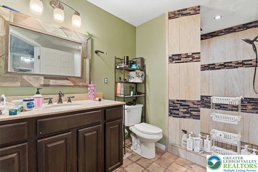 7567 Airport Road Bath, PA 18014 - Photo 55 of 67 a bathroom with a sink toilet and shower