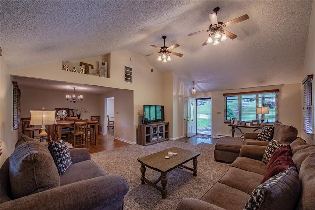 365 Boston Hollow Road Elizabeth, PA 15037 - Photo 6 of 25 Large 17x16 Living Room open to the Dining Room! Custom Blinds added!! Notice the Vaulted Ceiling!