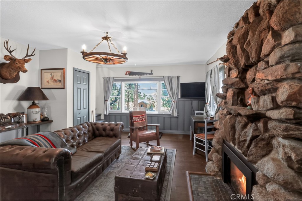 2775 View Running Springs, CA 92382 - Photo 10 of 30 a living room with furniture a flat screen tv and a fireplace
