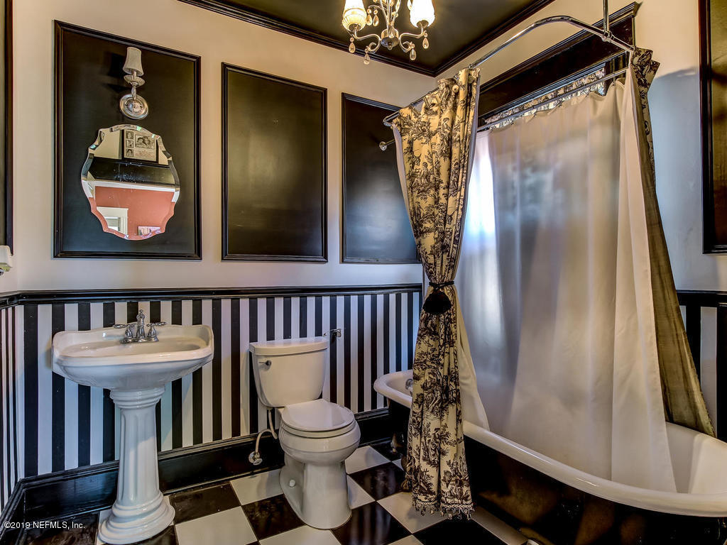 2230 Post Street Jacksonville, FL 32204 - Photo 22 of 34 a bathroom with a toilet and a shower curtain