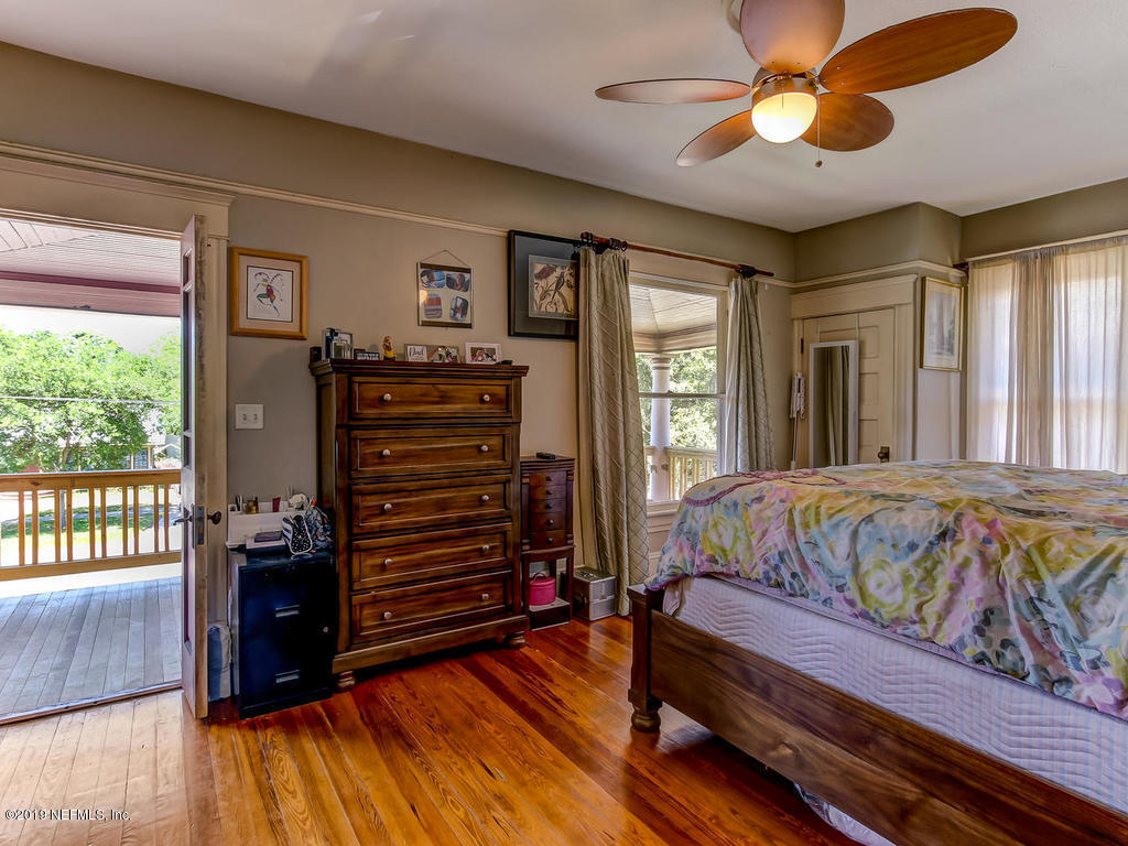 2230 Post Street Jacksonville, FL 32204 - Photo 25 of 34 a bedroom with a bed and a chandelier