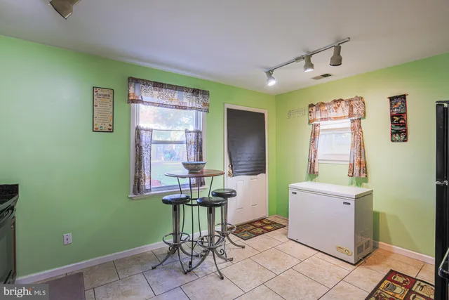 a view of entryway with a window and wooden floor