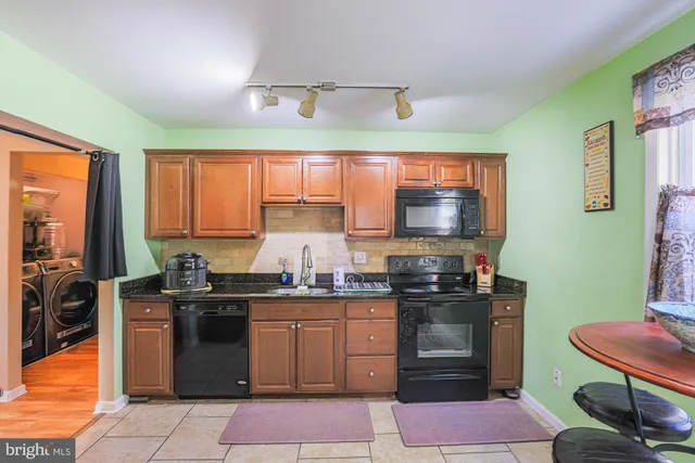 a kitchen with stainless steel appliances granite countertop counter space a sink and cabinets