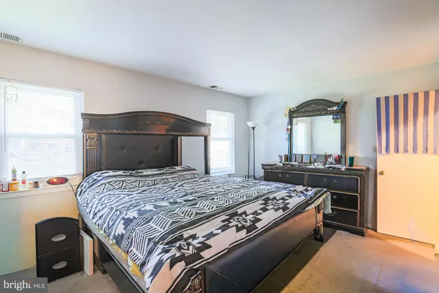 a bedroom with a bed and a dresser