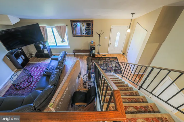 a view of staircase with furniture and lots of frames on wall