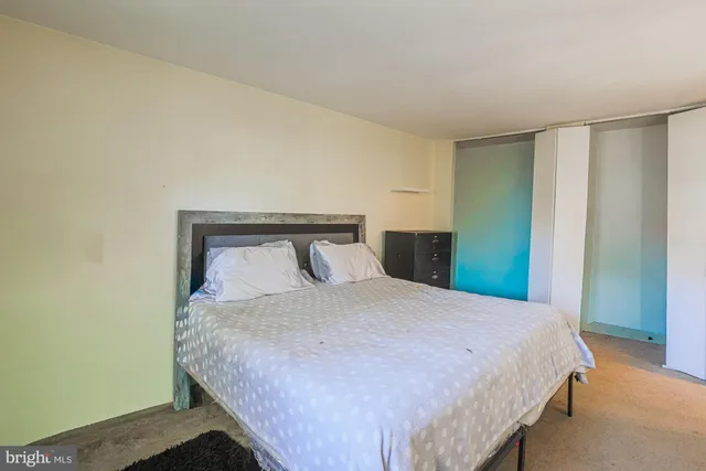 a bedroom with a large bed and a window