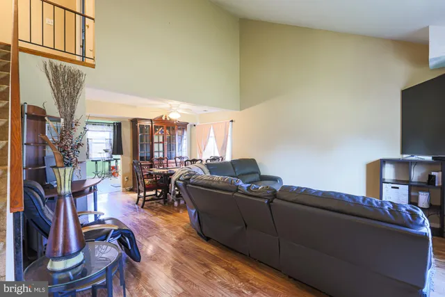 a view of a livingroom with wooden floor and furniture