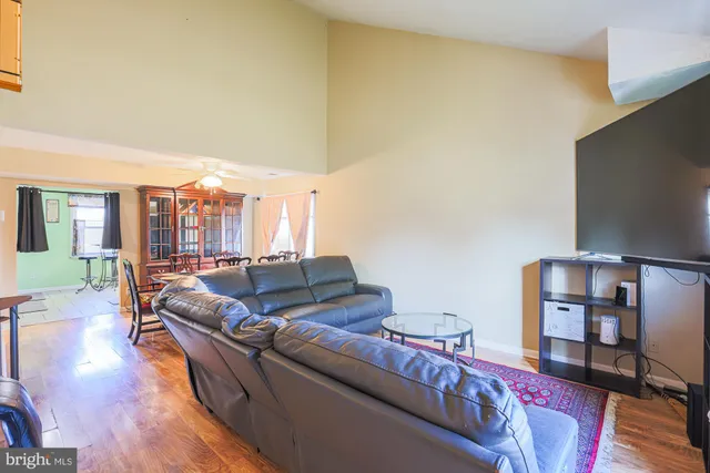 a living room with furniture hardwood floor and a book shelf