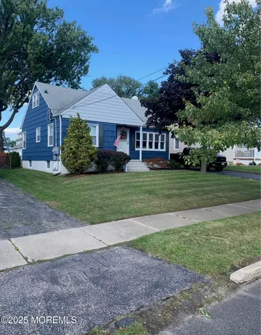 a view of a big house with a big yard and large trees