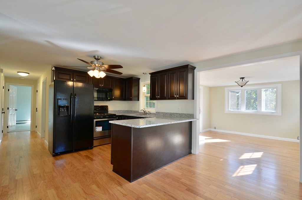 1117 Thompson Road Thompson, CT 06277 - Photo 8 of 20 a view of kitchen with refrigerator stove and wooden floor