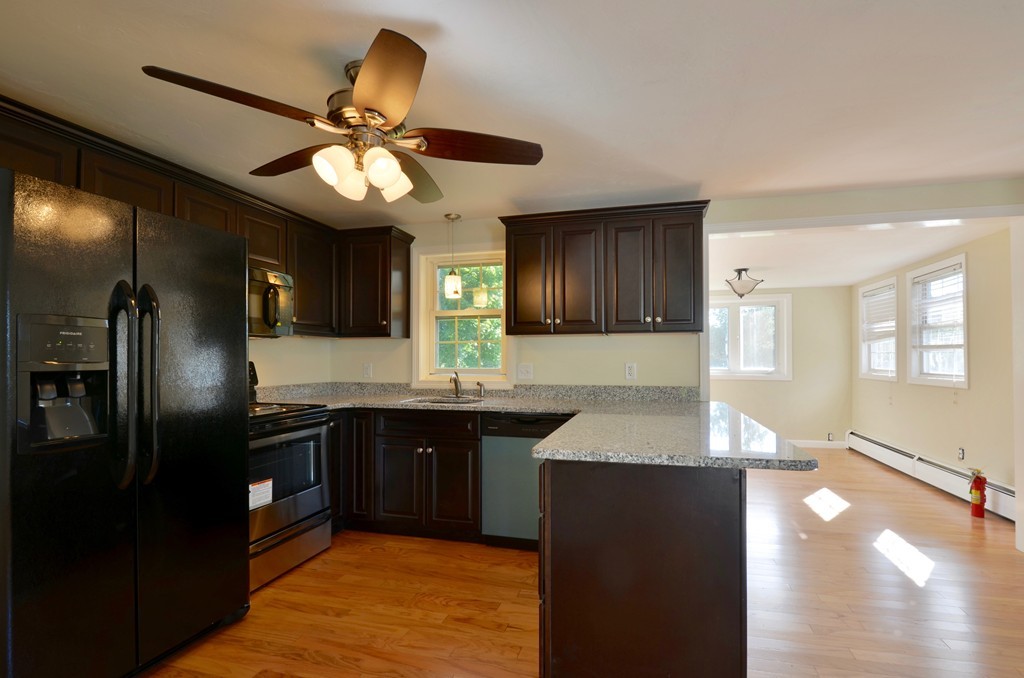 1117 Thompson Road Thompson, CT 06277 - Photo 9 of 20 a kitchen with stainless steel appliances granite countertop a refrigerator a sink dishwasher and a stove with wooden floor