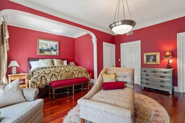 a bedroom with furniture and a chandelier
