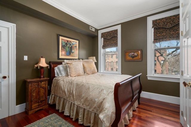 a bed sitting in a bedroom next to a window