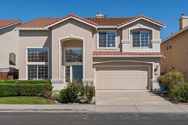 a front view of a house with a yard and garage