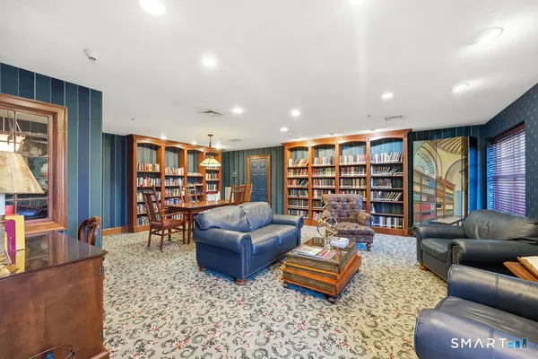 a living room with furniture and a book shelf