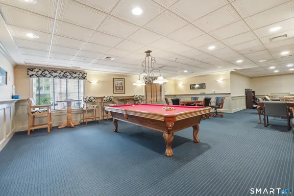 a living room with furniture and pool table