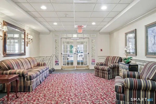 a living room with furniture and a chandelier