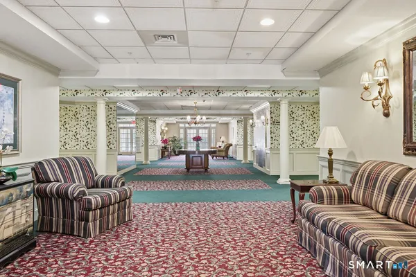 a living room with furniture and a chandelier
