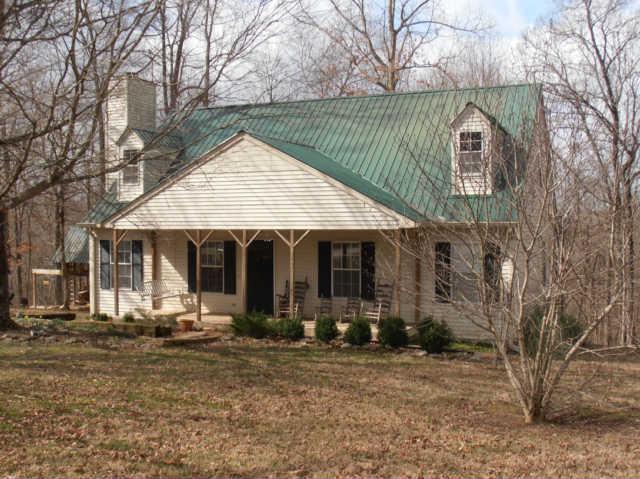 1568 Camp Ravine Road Burns, TN 37029 - Photo 1 of 20 a front view of a house with garden