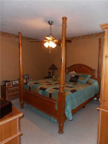 1568 Camp Ravine Road Burns, TN 37029 - Photo 12 of 20 a bed room with a bed and a television