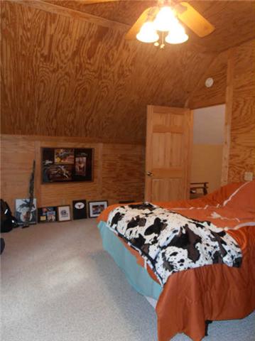 1568 Camp Ravine Road Burns, TN 37029 - Photo 16 of 20 a bedroom with a bed and a painting on the wall
